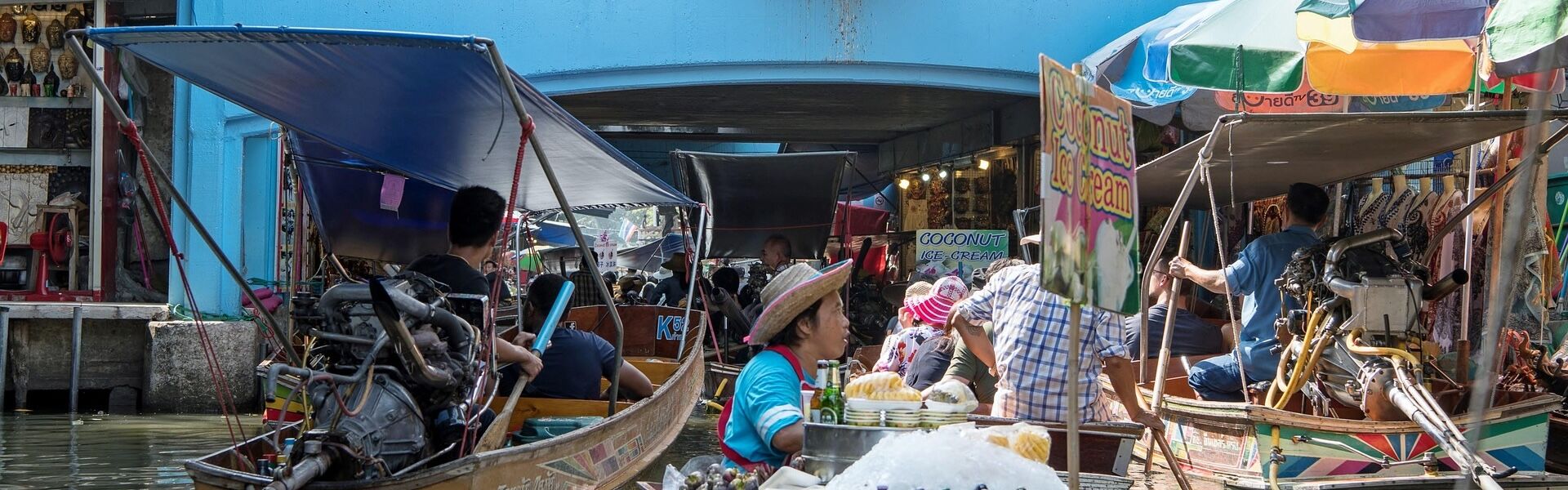 Damnoen Saduak’s lively waterways in Thailand on a Damnoen Saduak Travel banner by Legend Travel Group.